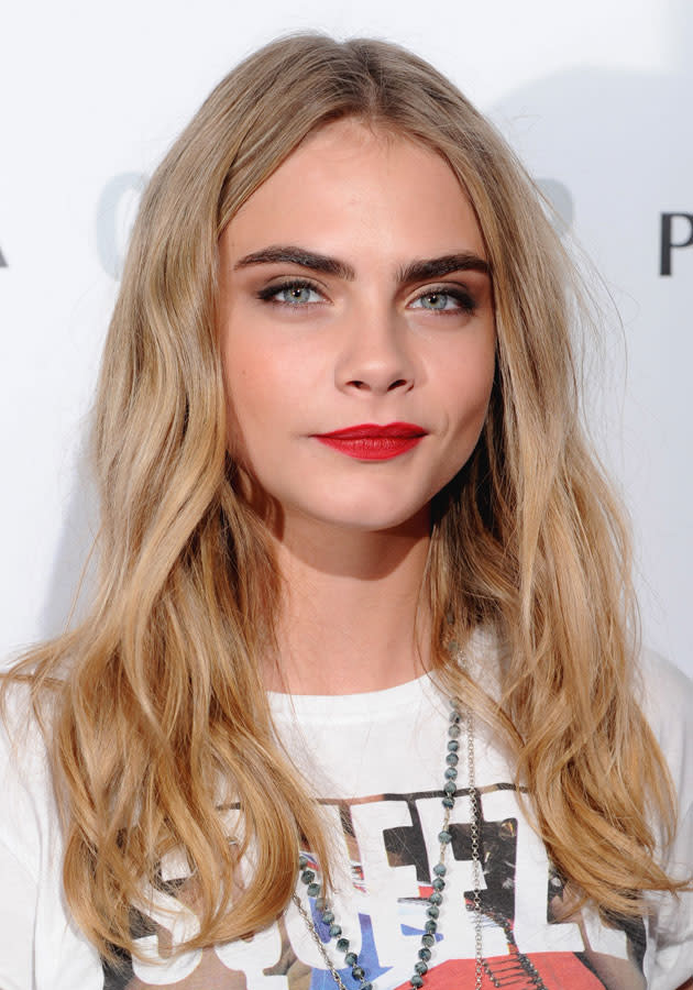 Cara Delevingne rocked red lips at the Glamour Awards. [Rex]