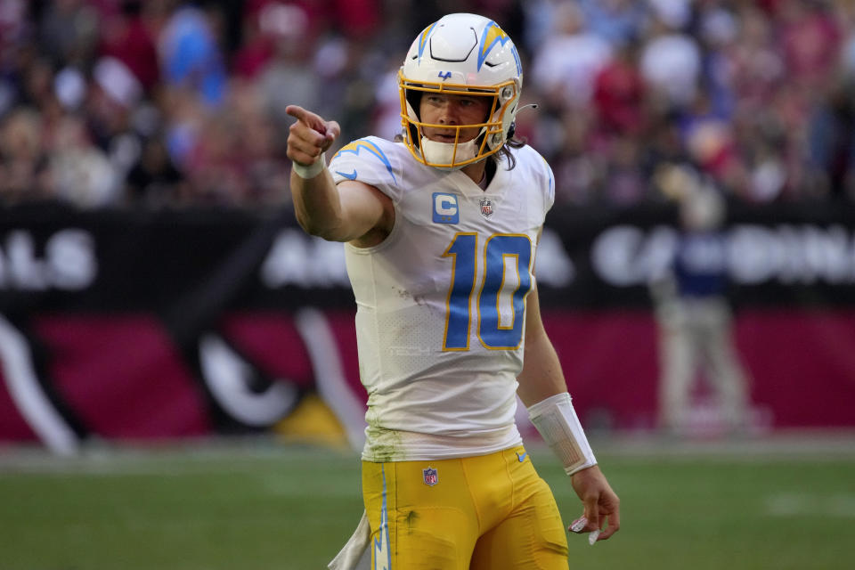 Los Angeles Chargers quarterback Justin Herbert (10) points during the second half of an NFL football game against the Arizona Cardinals, Sunday, Nov. 27, 2022, in Glendale, Ariz. (AP Photo/Rick Scuteri)