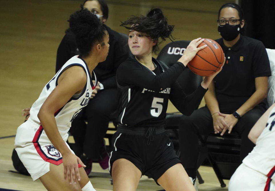 Providence guard Kyra Spiwak (5) looks for an opening against Connecticut guard Evina Westbrook (22) in the second half of an NCAA college basketball game at Harry A. Gampel Pavilion, Saturday, Jan. 9, 2021, in Storrs, Conn. (David Butler II/Pool Photo via AP)