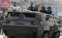 Riot police look from their armoured personnel vehicle during clashes with supporters of Muslim Brotherhood and ousted Egyptian President Mohamed Mursi at Nasr City district in Cairo, January 3, 2014. (REUTERS/ Mohamed Abd El Ghany)