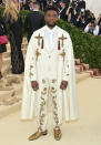 <p>Chadwick Boseman nailed the theme in a bespoke cape and suit by Versace. He accessorised the brocade-effect trousers with gold Christian Louboutin shoes and Bvlgari rings. <em>[Photo: Getty]</em> </p>