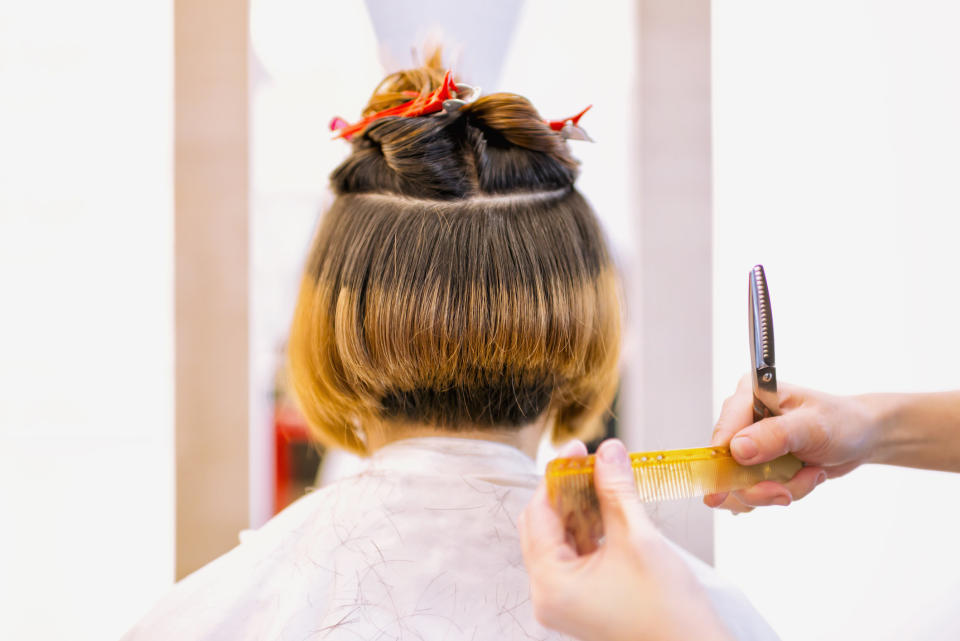 A woman receiving a haircut