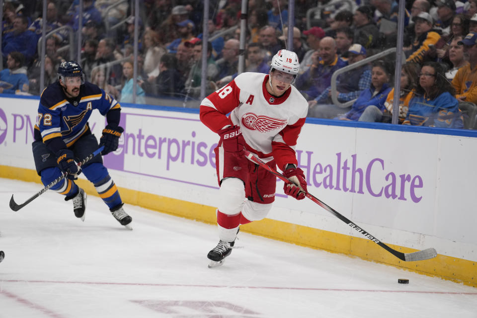 Detroit Red Wings' Andrew Copp (18) handles the puck as St. Louis Blues' Justin Faulk (72) defends during the first period of an NHL hockey game Tuesday, Dec. 12, 2023, in St. Louis. (AP Photo/Jeff Roberson)