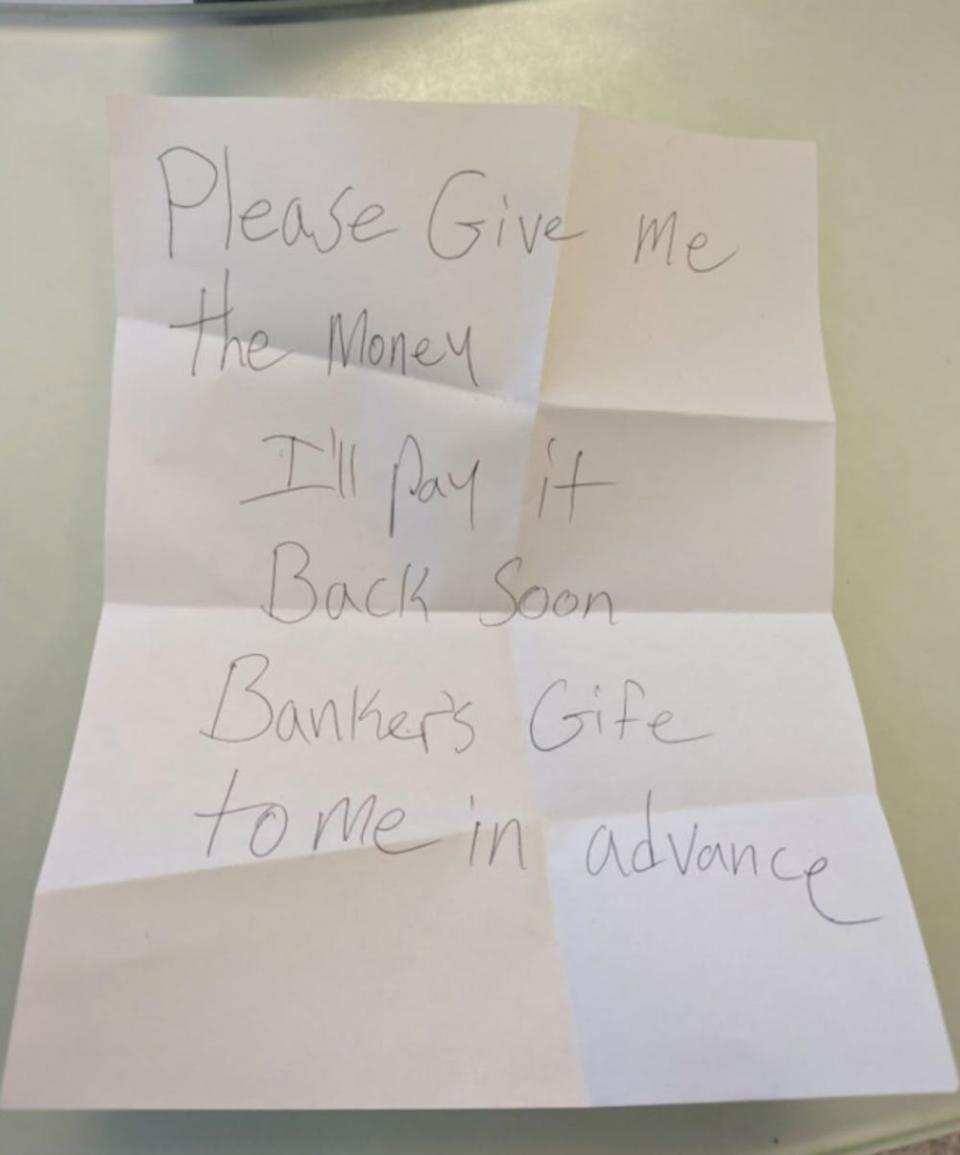 A penciled note on white paper allegedly written by Mohamed Worku and shown to an Illinois Citi Bank employee on January 22, 2024 saying: "please give me the money. I'll pay it back soon. Banker's gie to me in advance."