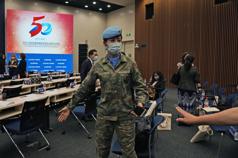 A Chinese United Nations peacekeeper attends a symposium to mark the 50th anniversary of the People's Republic of China's entry into the U.N. at the Foreign Ministry in Beijing on Friday, June 25, 2021. Foreign Minister Wang Yi said China remains deeply committed to United Nations peacekeeping efforts, where more than 2,400 Chinese troops and police are serving, a contribution that underscores China's increasing prominence in the world body. (AP Photo/Ng Han Guan)