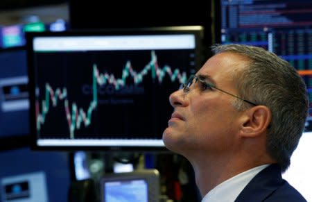 Traders work on the floor of the New York Stock Exchange (NYSE) in New York, U.S., September 18, 2018.  REUTERS/Brendan McDermid