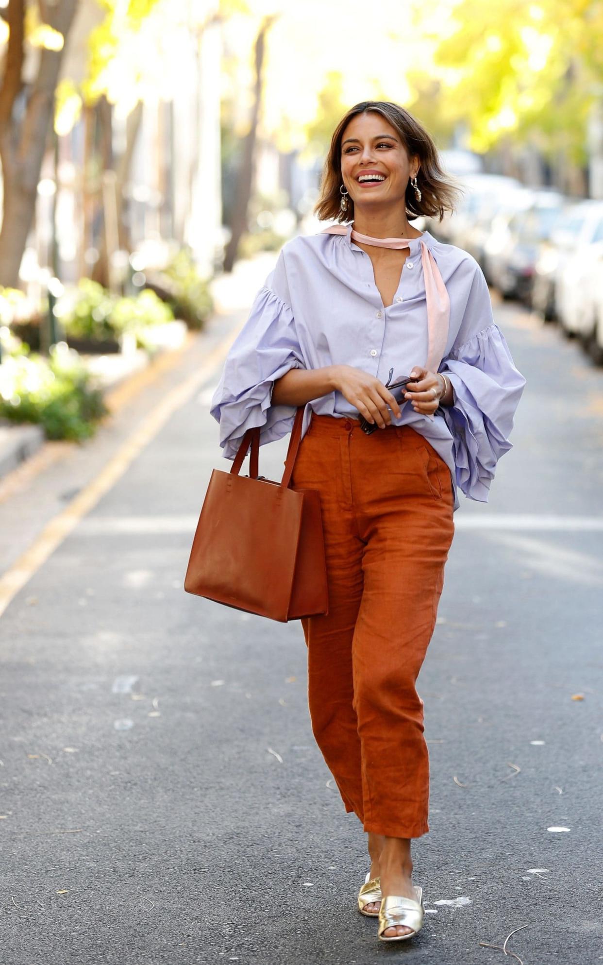Nathalie Kelley paired terracotta trousers with a blue blouse to excellent effect while out and about in Sydney, Australia  - Getty Images AsiaPac