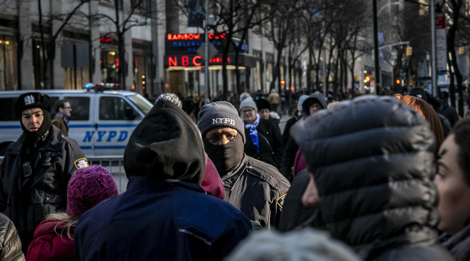 FILE - NYPD officers patrol the surrounding areas at Rockefeller Center in New York on Dec. 19, 2019. A court-appointed federal monitor reported Monday, June 5, 2023, that New York City's reliance on the tactic known as “stop and frisk" as part of a new initiative to combat gun violence is harming communities of color and running afoul of the law. (AP Photo/Bebeto Matthews, File)