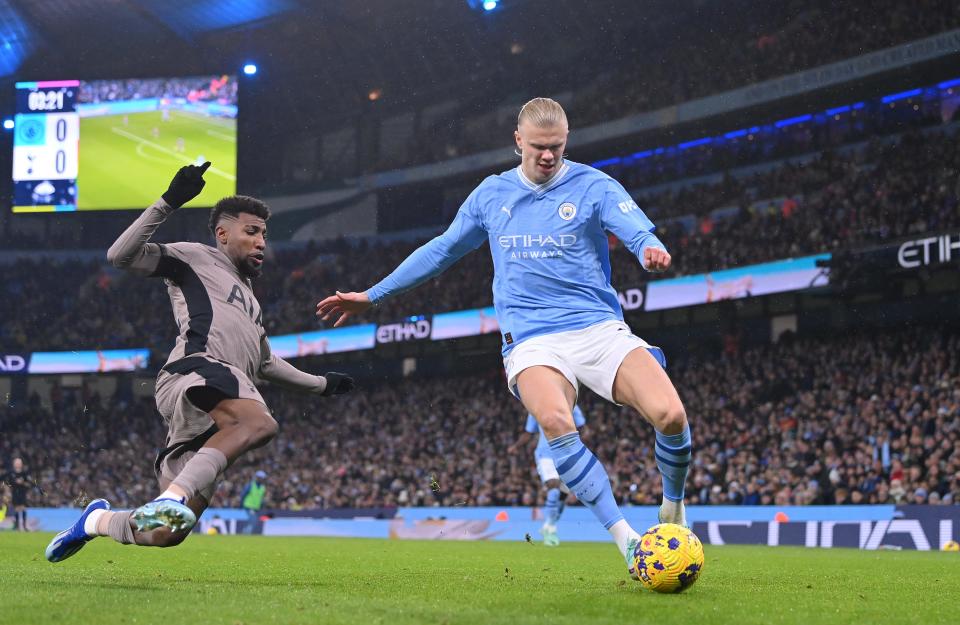 MANCHESTER, ENGLAND - DECEMBER 03: Manchester City striker Erling Haaland is challenged by Emerson Royal of Tottenham during the Premier League match between Manchester City and Tottenham Hotspur at Etihad Stadium on December 03, 2023 in Manchester, England. (Photo by Stu Forster/Getty Images)