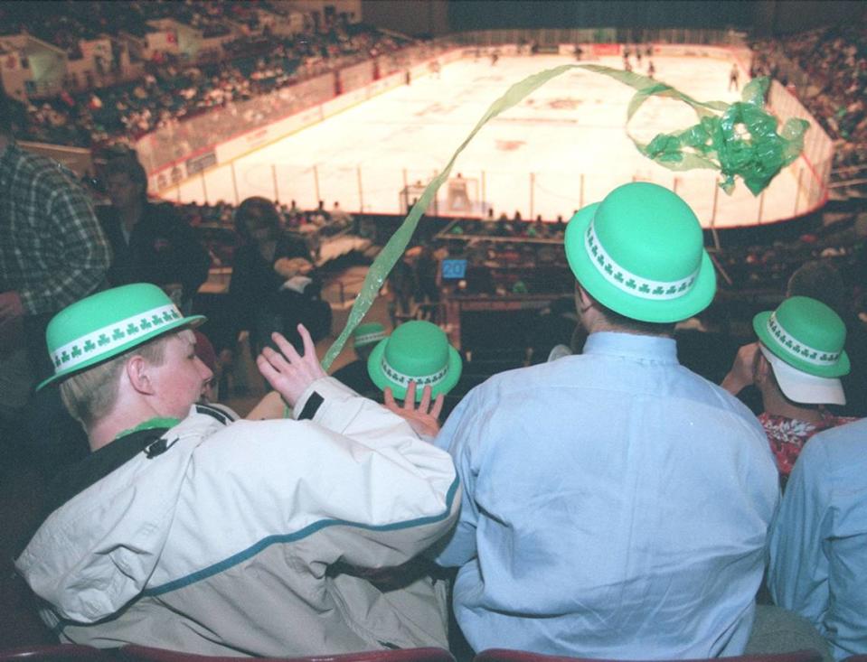 March 17, 2001: Erik Ahlund, 16, throws a green St. Patrick’s Day streamer at 18-year-old B.J. Cotton during a Brahmas hockey game at the Fort Worth Convention Center.