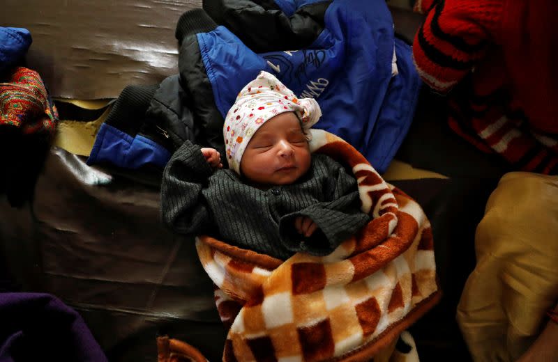 One-day-old baby is pictured after his mother Shabana Parveen and her family fled their home following clashes between people demonstrating for and against a new citizenship law in a riot affected area in New Delhi