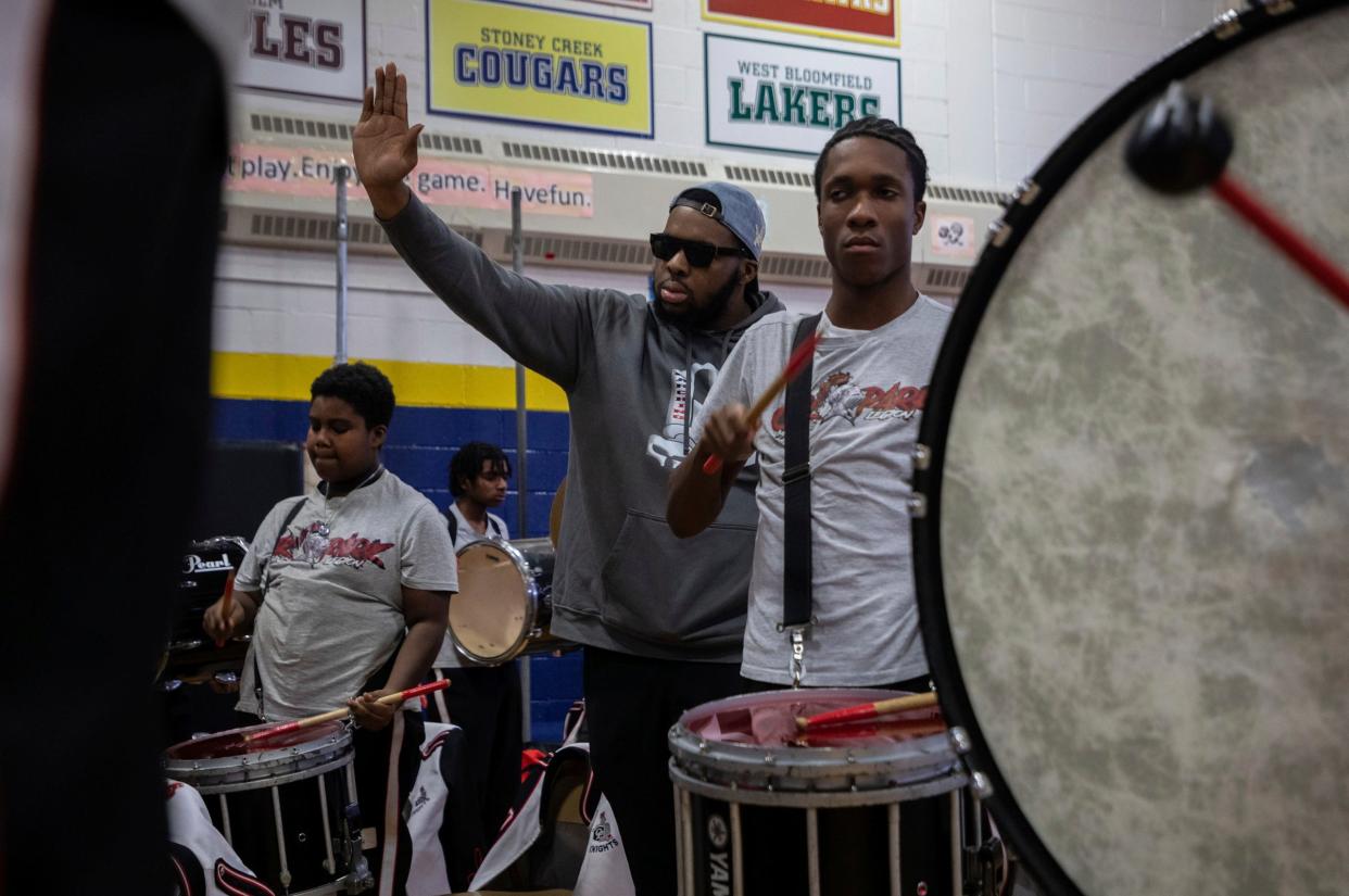 Mykel Young, percussion instructor at Oak Park High School and a Forever Illustrating Real Entertainment (FIRE) member, performs next to his students in front of a large crowd during the 8th annual Harvest Festival inside the University High School Academy's gymnasium in Detroit on Wednesday, Nov. 22, 2023.