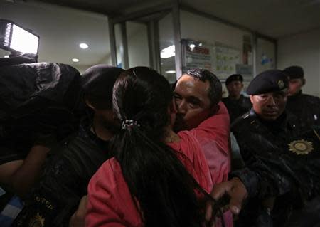 Waldemar Lorenzana (back C) greets a relative after arriving at the Supreme Court of Justice in Guatemala City, September 17, 2013. REUTERS/Jorge Dan Lopez