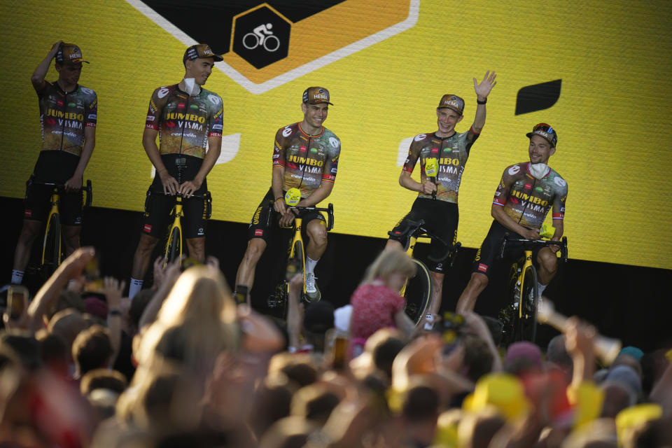 Slovenia's Primoz Roglic, right, and Denmark's Jonas Vingegaard, second right, and other team Jumbo Visma riders line up during the team presentation ahead of the Tour de France cycling race in Copenhagen, Denmark, Wednesday, June 29, 2022. The race starts Friday, July 1, the first stage is an individual time trial over 13.2 kilometers (8.2 miles) with start and finish in Copenhagen. (AP Photo/Daniel Cole)