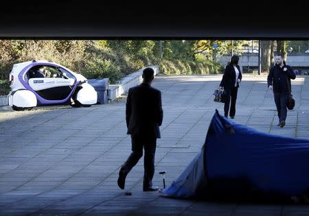 A driverless pod approaches a homeless person's tent as it is tested in Milton Keynes, Britain, October 11, 2016. REUTERS/Darren Staples