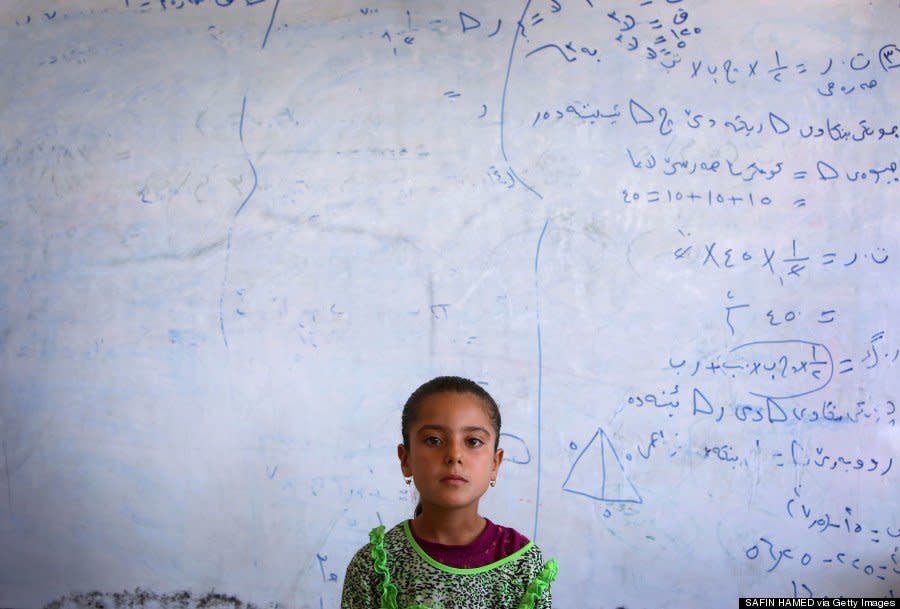 A Yazidi girl who fled with her family stands in a school where they are taking shelter in Dohuk on August 5, 2014. (SAFIN HAMED/AFP/Getty Images)