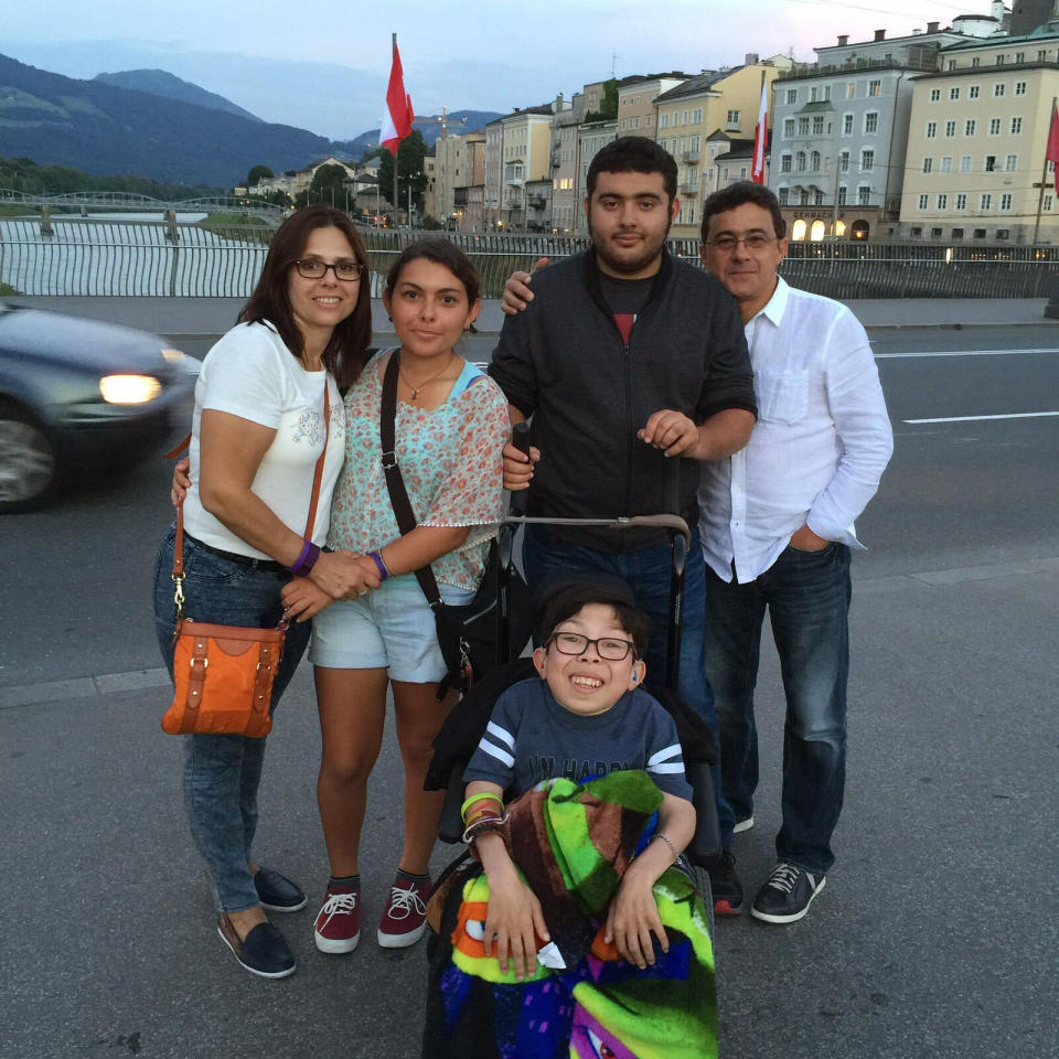 In this summer 2016 photo provided by Maria Elena Cardenas shows her, far left, and her husband Gustavo Cardenas, far right, with their children Maria, left, Gus, right, and Sergio, below, as they vacation in Austria. Since Venezuela's government arrested Gustavo and five other Citgo employees in November 2017 in Caracas, their 18-year-old son Sergio, who suffers from a rare metabolic disease called mucolipidosis, has been having panic attacks and screaming at night for his Dad. Maria fears that he could die before his father’s release. (Maria Elena Cardenas via AP)