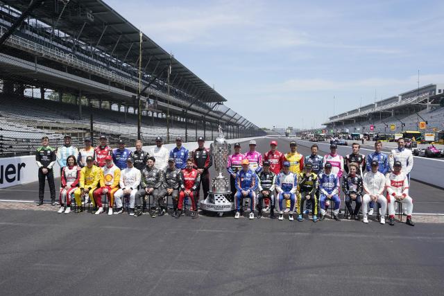 The field for the 107th running of the Indianapolis 500 auto race gather for a photo at Indianapolis Motor Speedway, Monday, May 22, 2023, in Indianapolis. The drivers are, front row from left, Katherine Legge, of England, Scott McLaughlin, of New Zealand, Josef Newgarden, Felix Rosenqvist, of Sweden, Pato O'Ward, of Mexico, Tony Kanaan, of Brazil, Will Power, of Australia, Scott Dixon, of New Zealand, Takuma Sato, of Japan, Alex Palou, of Spain, Colton Herta, Colton Herta, Devlin DeFrancesco, of Canada, Santino Ferrucci, Benjamin Pedersen, of Denmark, and RC Enerson. Second row from left, Callum Ilott, of England, Agustin Canapino, of Argentina, Jack Harvey, of England, Christian Lundgaard, of Denmark, Conor Daly, Ed Carpenter, Alexander Rossi, Ryan Hunter-Reay, Helio Castroneves, of Brazil, Simon Pagenaud, of France, Marcus Ericsson, of Sweden, Romain Grosjean, of Switzerland, Marco Andretti, Kyle Kirkwood, David Malukas, Sting Ray Robb and Stefan Wilson, of England. (AP Photo/Darron Cummings)