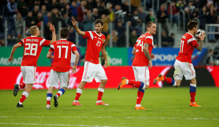 Soccer Football - International Friendly - Russia vs France - Saint-Petersburg Stadium, Saint Petersburg, Russia - March 27, 2018 Russia’s Fedor Smolov celebrates with team mates after scoring their first goal REUTERS/Anton Vaganov