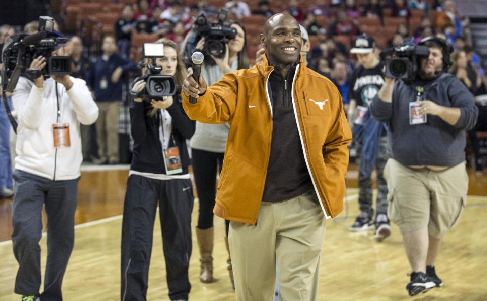 FILE - In this Wednesday, Jan. 8, 2014 file photo, Texas new head football coach Charlie Strong speaks to fans during a timeout against Oklahoma in the first half of an NCAA college basketball game in Austin, Texas. There are 125 colleges playing in the top-level Football Bowl Subdivision. In 2013, 13 of them had black coaches. That was down from 15 in 2012 and an all-time high of 17 in 2011. Strong and James Franklin at Penn State have not been replaced by African-Americans, so the overall numbers remain low. (AP Photo/Austin American- Statesman, Ricardo B. Brazziell) MANDATORY CREDIT: AUSTIN AMERICAN- STATESMAN, RICARDO B. BRAZZIELL