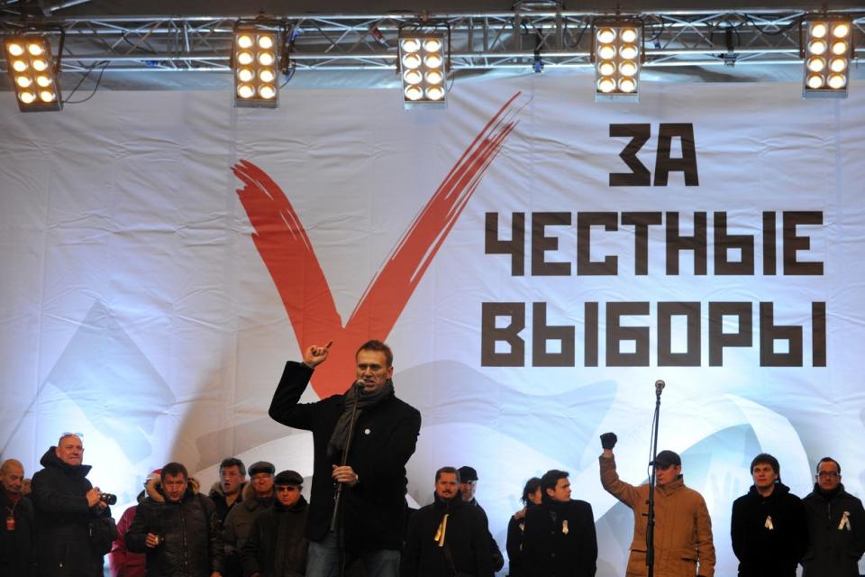 Anti-Kremlin blogger Alexei Navalny speaks during a rally against the December 4 parliament elections in Moscow, on December 24, 2011. The backdrop reads: "For honest vote!" Tens of thousands of people filled today an avenue in Moscow to protest against the alleged rigging of parliamentary polls in a new challenge to Russian strongman Vladimir Putin's authority. (Kirill Kudryavtsev/AFP via Getty Images)