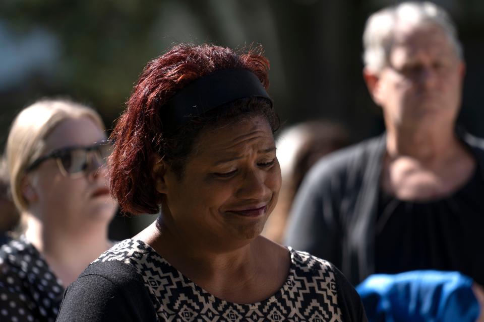 Ann Robinson sheds a tear Monday, Sept. 26, 2022, at Oaklawn Memorial Gardens in Fishers. Robinson and dozens of others volunteered to carry unclaimed remains from a hurst to be laid to rest. 