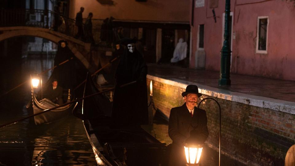 l r riccardo scamarcio as vitale portfoglio and kenneth branagh as hercule poirot in 20th century studios' a haunting in venice photo by rob youngso 2023 20th century studios all rights reserved