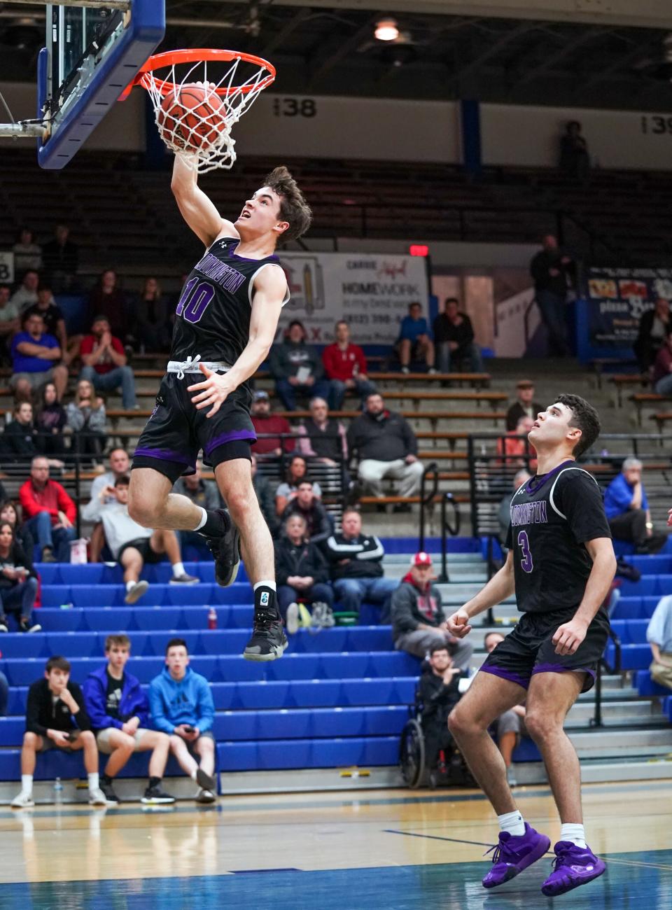 Bloomington South’s Connor Hickman (10) dunks as teammate Anthony Leal looks on during the Columbus North Sectional opener against Columbus East in March of 2020. The Panthers won 67-34.