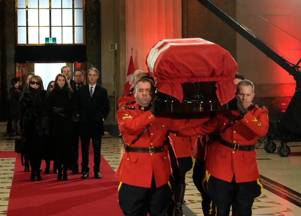 Members of the Mulroney family follow as an honour guard carries the casket of former prime minister Brian Mulroney into the Sir John A. Macdonald building opposite Parliament Hill in Ottawa on Tuesday, March 19, 2024.