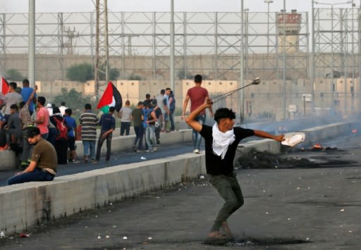 A Palestinian uses a slingshot during demonstrations at the Erez border crossing with Israel in the northern Gaza Strip on October 3, 2018