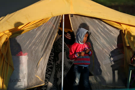 A Venezuelan migrant girl stands outside a tent inside a temporary humanitarian camp that is closed by the government, in Bogota, Colombia January 15, 2019. REUTERS/Luisa Gonzalez