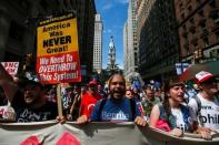 City Hall is seen in the background as supporters of U.S. Senator Bernie Sanders take part in a protest march ahead of the 2016 Democratic National Convention in Philadelphia, Pennsylvania, July 24, 2016. REUTERS/Adrees Latif