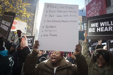 Protesters demonstrate outside of Macy's in Herald Square during the Black Friday shopping day in New York November 28, 2014. REUTERS/Carlo Allegri