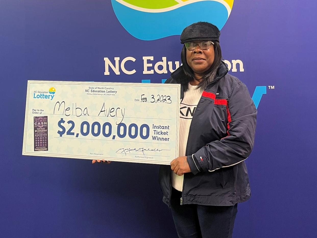 Pisgah Forest's Melba Avery poses with her $2 million check after winning a scratch off in Transylvania County.