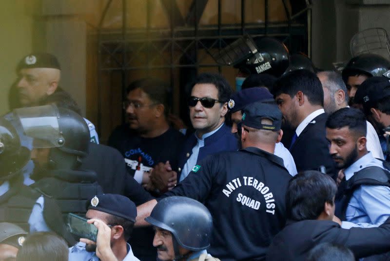 FILE PHOTO: Security officers escort Pakistan's former Prime Minister Imran Khan as he appeared in Islamabad High Court