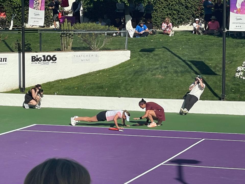 Croatian tennis player Donna Vekić does pushups after Tunisian tennis player Ons Jabeur served an ace at the Desert Smash celebrity charity event at the La Quinta Resort & Club on Tuesday, March 5, 2024.
