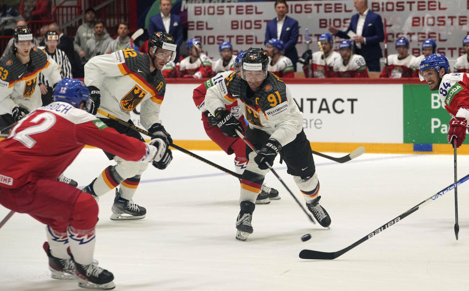 Germany's Moritz Mueller is challenged during the Hockey World Championship quarterfinal match between Germany and the Czech Republic in Helsinki, Finland, Thursday May 26, 2022. (AP Photo/Martin Meissner)