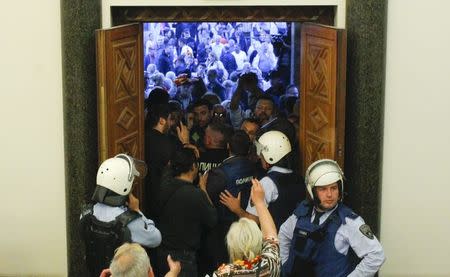 Protesters entered Macedonia's parliament after the governing Social Democrats and ethnic Albanian parties voted to elect an Albanian as parliament speaker in Skopje. Macedonia April 27, 2017. REUTERS/Ognen Teofilovski