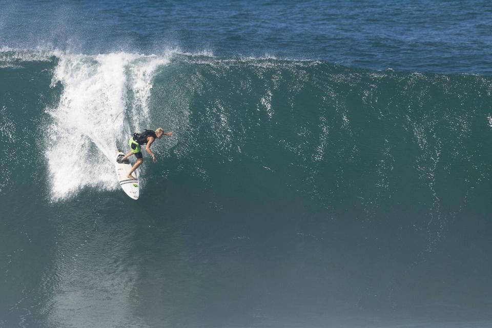 Surfer Keala Kennelly of Hawaii surfs during the Da Hui Backdoor Shootout at Pipeline, on the north shore of Oahu, Hawaii, on January 16, 2022.