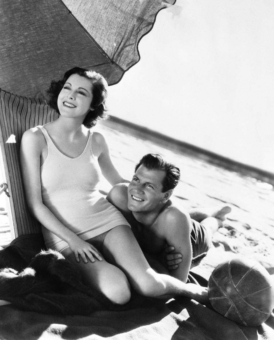 <p>The movie stars relax on a Santa Monica beach just a few months after their October 1933 nuptials. </p>