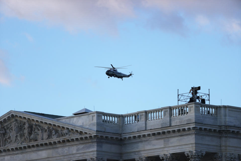 WASHINGTON, DC - JANUARY 20: Marine One carrying President Donald Trump and first lady Melania Trump passes over the U.S. Capitol as they depart from the White House ahead of the inauguration of U.S. President-elect Joe Biden on January 20, 2021 in Washington, DC. (Photo by Joe Raedle/Getty Images)