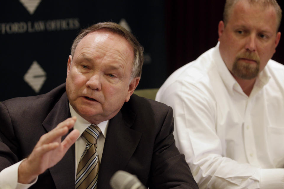 Robert A. Clifford, attorney for Robert Schmidt, right, of Hutchinson, Minn., and John W. Jentz, of St. Peter, Minn., who were both severely burned in April 2010 at a grain elevator explosion in downstate Illinois, speaks about their settlement at a news conference at Clifford Law Offices Monday, June 4, 2012, in Chicago. Schmidt, Jentz and a third co-worker from Iowa were awarded $181 million in a lawsuit against ConAgra Foods Inc. and a subcontractor. (AP Photo/M. Spencer Green)