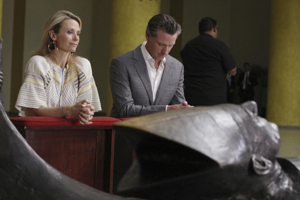 California Gov. Gavin Newsom with his wife, Jennifer Siebel Newsom visit the tomb of Archbishop Oscar Romero at Metropolitan Cathedral in San Salvador, El Salvador, Sunday, April 7, 2019. Newsom visited the tomb of Archbishop Romero, the Salvadoran priest assassinated in 1980 due to his advocacy for human rights and the poor. (AP Photo/Salvador Melendez, Pool)