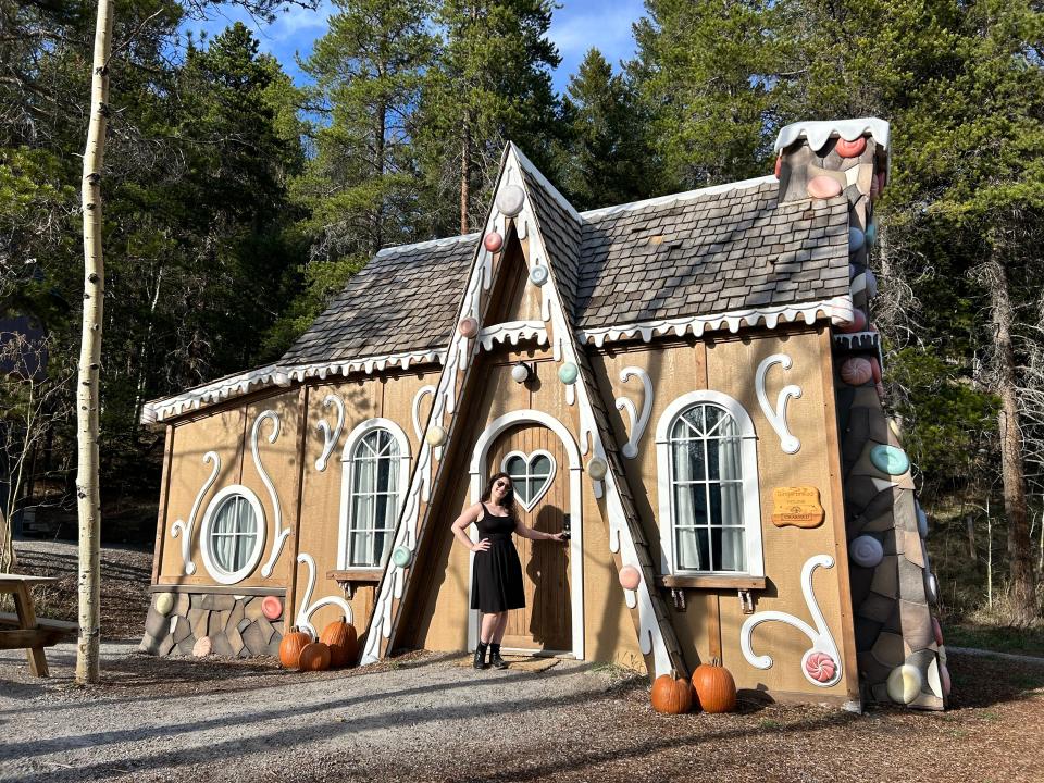 gingerbread house exterior with author in front