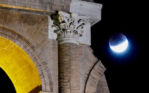 July's full moon, also known as the Thunder Moon, is seen over the Colosseum during a partial lunar eclipse, in Rome, late Tuesday, July 16, 2019. - Credit: Andrew Medichini/AP