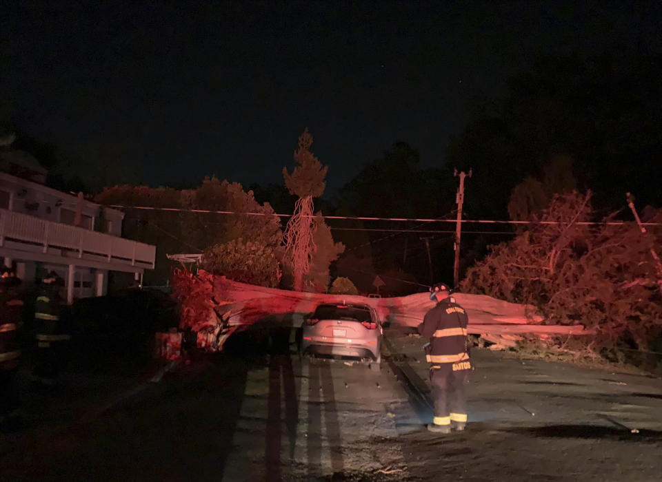 This early Monday, Oct. 11, 2021, photo provided by CalFire shows one of several vehicles damaged during a wind event in El Granada village in the coastal area of northern San Mateo County, Calif. (CalFire via AP)