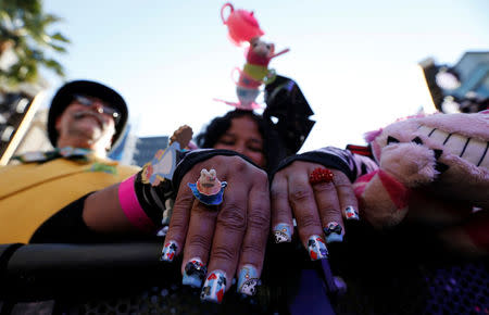 Fan Maria Sims shows off her fingernails while waiting for a performance by soundtrack artist Pink at the premiere of "Alice Through the Looking Glass" at El Capitan theatre in Hollywood, U.S., May 23, 2016. REUTERS/Mario Anzuoni