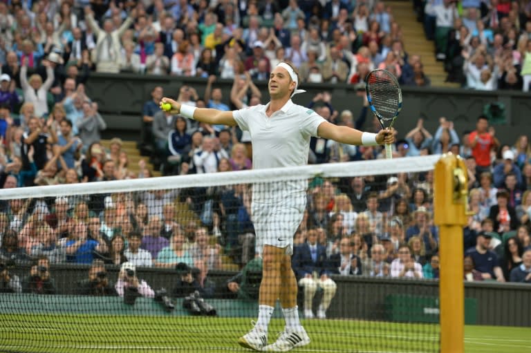 Britain's Marcus Willis celebrates winning his first game of the match in the second set against Switzerland's Roger Federer, at Wimbledon on June 29, 2016