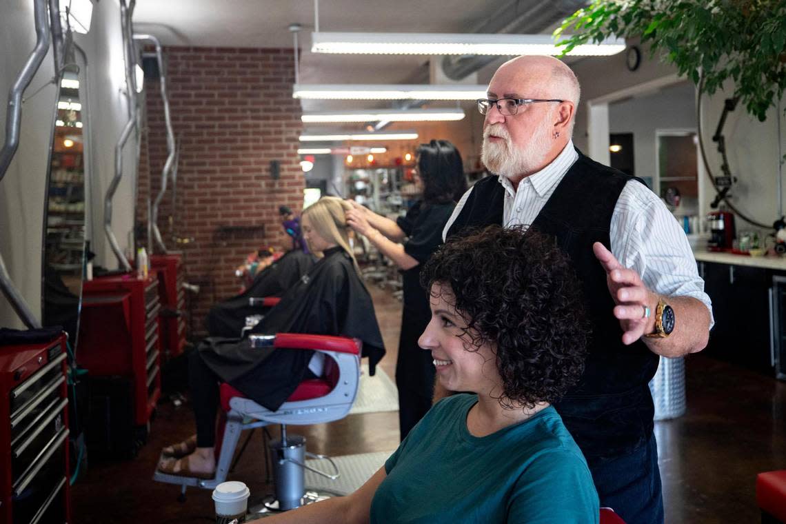 Magnolia Ave. Salon owner Tim McDowell spruces the freshly-cut hair of his client Dana Zachry, in Fort Worth, Texas, on Saturday, Sept. 10, 2022.