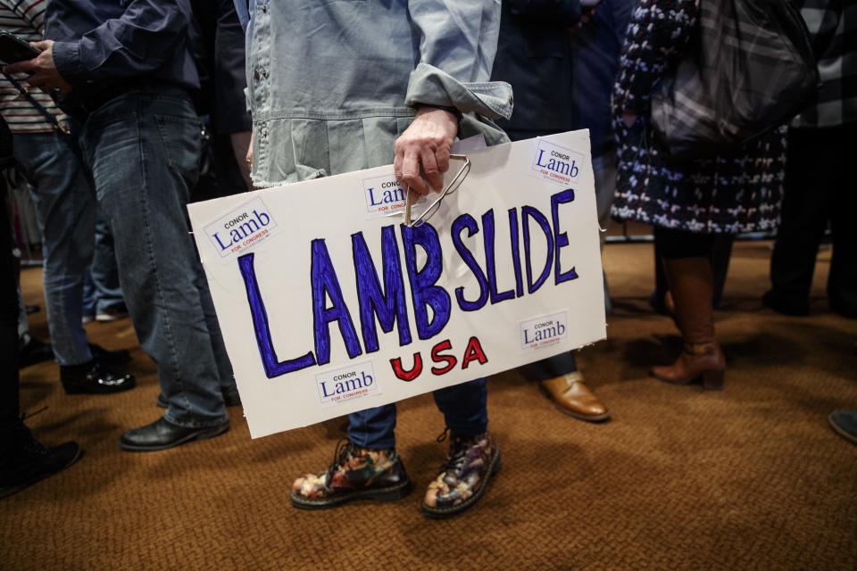 A supporter holds a sign in support of Rep. Conor Lamb on March 13, 2018.